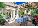 Cozy outdoor patio featuring a dining area, a grill, a pergola, and comfortable lounging furniture at 5205 N 8Th Pl, Phoenix, AZ 85014