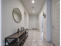 Bright entryway featuring tiled floors, neutral walls, and an attractive console table with decor at 523 S 201St Ave, Buckeye, AZ 85326