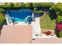 Aerial view of the backyard featuring a sparkling pool, hot tub, and lush landscaping at 6105 W Kimberly Way, Glendale, AZ 85308