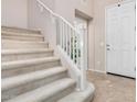 Carpeted staircase with white railing leading to the upper level of the home at 6713 E Elmwood St, Mesa, AZ 85205