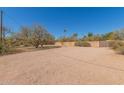 Large gravel front yard area, partially enclosed with a block fence, offering ample space at 7102 E Larkspur Dr, Scottsdale, AZ 85254