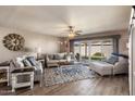 Sun-filled living room with hardwood floors, stylish furniture, and sliding glass doors to the patio at 7644 E Mariposa Dr, Scottsdale, AZ 85251