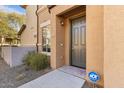 Inviting front entrance with a gray door, ADT security sign, and a charming exterior at 7726 E Baseline Rd # 110, Mesa, AZ 85209