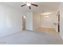 Bright living room showing carpet, entry to dining area, and an archway to another room at 7726 E Baseline Rd # 110, Mesa, AZ 85209