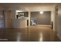 Bright and airy living room featuring wood-look floors and open access to the kitchen at 7950 E Starlight Way # 128, Scottsdale, AZ 85250