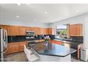 Well-equipped kitchen featuring granite countertops, stainless steel appliances, and a central island at 8421 W Alex Ave, Peoria, AZ 85382