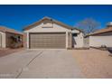 A home featuring a two-car garage with stone accents and xeriscaping for low maintenance at 8772 W Grovers W Ave, Peoria, AZ 85382