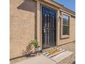 Inviting front entrance featuring a secure black metal door and 'Home Sweet Home' welcome mat at 9705 E Butte St, Mesa, AZ 85207