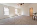 Bright living room with plush carpeting, large windows and neutral paint at 9705 E Butte St, Mesa, AZ 85207