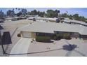 Drone view of a charming single-story home featuring a two-car garage, low-maintenance landscaping, and a welcoming facade at 9806 W Long Hills Dr, Sun City, AZ 85351