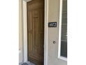 Elegant wooden front door featuring decorative panels and a modern number plaque, adding curb appeal at 11000 N 77Th Pl # 1072, Scottsdale, AZ 85260