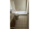 Full bathroom with tiled walls, a bathtub, a toilet and vanity at 1111 E Village Circle N Dr, Phoenix, AZ 85022