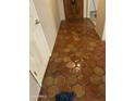 Inviting entryway boasts beautiful terracotta tile flooring and a solid wood front door at 1111 E Village Circle N Dr, Phoenix, AZ 85022