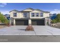 New construction, two-story home featuring a gray roof, dual black garages and desert mountain views at 1115 E Mcneil St, Phoenix, AZ 85042