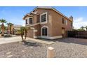 Two-story home featuring a two car garage and desert landscaping at 11328 N 89Th Dr, Peoria, AZ 85345