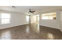 Spacious living room boasts tile flooring, neutral walls, and a ceiling fan for added comfort at 11609 W Corrine Dr, El Mirage, AZ 85335