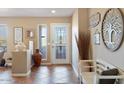 Bright foyer features tile floors, decorative accents and a white entry door with glass at 12530 W Skylark Dr, Sun City West, AZ 85375