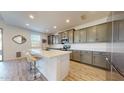 Bright kitchen featuring stainless steel appliances, island with seating, and gray cabinets at 14420 W Faye Way, Surprise, AZ 85387