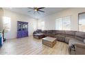 Cozy living room features a comfortable sectional, large windows, and a decorative cabinet at 14420 W Faye Way, Surprise, AZ 85387