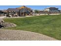 Community playground area with covered seating, play equipment, and green grass at 14420 W Faye Way, Surprise, AZ 85387