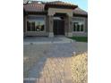 Inviting front entrance with a brick walkway and landscaped features creating curb appeal at 14432 W Robertson Dr, Sun City West, AZ 85375