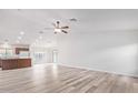 Bright open-concept living room featuring modern flooring, ample natural light, and a ceiling fan at 14952 N 172Nd Ln, Surprise, AZ 85388