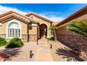 Inviting home entrance with a stone walkway and tasteful landscaping at 15492 W Whitton Ave, Goodyear, AZ 85395