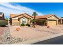 Charming single-story home featuring desert landscaping and a spacious two-car garage at 15492 W Whitton Ave, Goodyear, AZ 85395