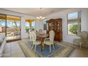 Elegant dining room with a beautiful wood table and sliding door access at 16949 W Oasis Springs Way, Surprise, AZ 85387