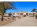 Charming single-story home with a light-colored exterior and a convenient covered carport at 1716 W Weldon Ave, Phoenix, AZ 85015