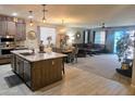 Well-lit open-concept kitchen with an island and dining area at 17743 W Robin Ln, Surprise, AZ 85387