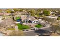 An impressive aerial view of the home, landscaped yard, inviting pool, and solar panels on roof in a neighborhood at 19864 E Via Del Oro --, Queen Creek, AZ 85142