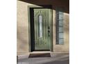 A decorative sage-green front door featuring a glass window and security features for enhanced curb appeal at 21748 W Sonora St, Buckeye, AZ 85326