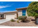 Well-maintained single-story home featuring desert landscaping and an attached two-car garage at 22754 W Moonlight Path, Buckeye, AZ 85326