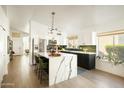 Modern kitchen features a marble island, stainless steel appliances, and sleek cabinetry at 23843 N 73Rd St, Scottsdale, AZ 85255