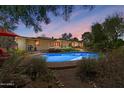 Inviting backyard pool area featuring lush landscaping, comfortable seating, and a well-maintained patio at 318 E Concorda Dr, Tempe, AZ 85282