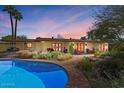 Inviting backyard pool area featuring lush landscaping, comfortable seating, and a well-maintained patio at 318 E Concorda Dr, Tempe, AZ 85282