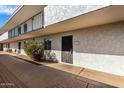 Condo exterior view with security door, small window, and common area with walkway at 3313 N 68Th St # 111, Scottsdale, AZ 85251