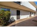 Condo exterior view featuring a secure entry door and well-maintained common area with tile accents at 3313 N 68Th St # 111, Scottsdale, AZ 85251