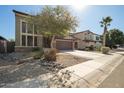 View of the home's two-car garage and neutral stucco at 33731 N Slate Creek Dr, San Tan Valley, AZ 85143