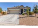 Charming single-Gathering home with a two-car garage, desert landscaping and tile roof at 3973 N 310Th Ln, Buckeye, AZ 85396