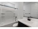 Modern bathroom featuring a combo tub and shower, contemporary vanity, and dark fixtures at 4133 W Eli Dr, San Tan Valley, AZ 85144