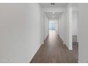 Hallway view with hard wood floors that lead into an open living area with windows to bring in light at 4145 W Eli Dr, San Tan Valley, AZ 85144