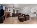 Cozy living room features a brick fireplace and a comfortable sectional sofa at 4154 W Grovers Ave, Glendale, AZ 85308