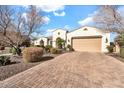 Well-maintained home featuring a large driveway, desert landscaping, and an attached garage at 4926 S Hemet St, Gilbert, AZ 85298