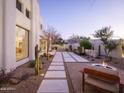 Serene backyard featuring a water feature, desert landscaping, and a fire pit with seating at 5101 N Casa Blanca Dr # 335, Paradise Valley, AZ 85253