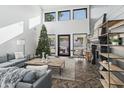 Spacious living room boasts tall windows, fireplace, hardwood floors, and modern finishes at 5601 E Caballo Dr, Paradise Valley, AZ 85253