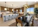 Bright eat-in kitchen featuring wood cabinets, stainless steel appliances, and a large center island with bar seating at 5711 S Quartz St, Gilbert, AZ 85298