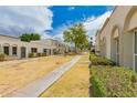 Exterior community view with lush lawns, mature trees, and inviting walkways between units at 5809 E Thomas Rd, Scottsdale, AZ 85251