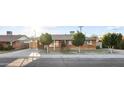 Charming single-story brick home featuring a covered carport, mature landscaping, and a well-maintained front yard at 6808 N 33Rd Ave, Phoenix, AZ 85017